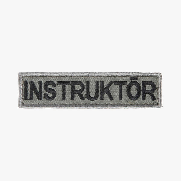 Snigel INSTRUKTÖR-märke (Litet) 100 × 25 mm – Kardborremärke (Grå/Svart)